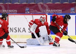 MALMO, SWEDEN - APRIL 1: Switzerland's Florence Schelling #41 makes a pad save while Anja Stiefel #63 and Laura Benz #21 look on during quarterfinal round action against Finland at the 2015 IIHF Ice Hockey Women's World Championship. (Photo by Andre Ringuette/HHOF-IIHF Images)

